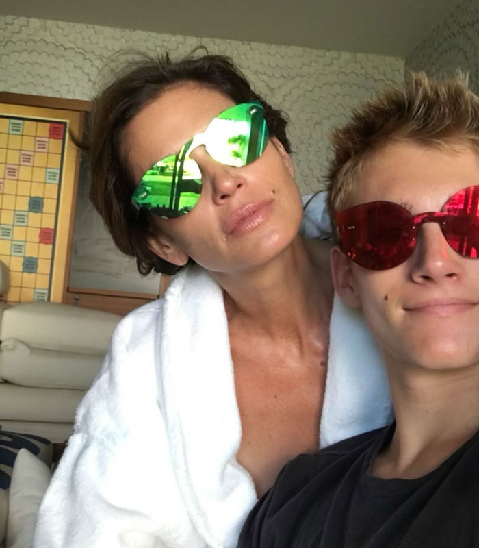 Cindy Crawford and her son posing together with sunglasses in a casual setting. Cindy Crawford and her son posing together with sunglasses in a casual setting.