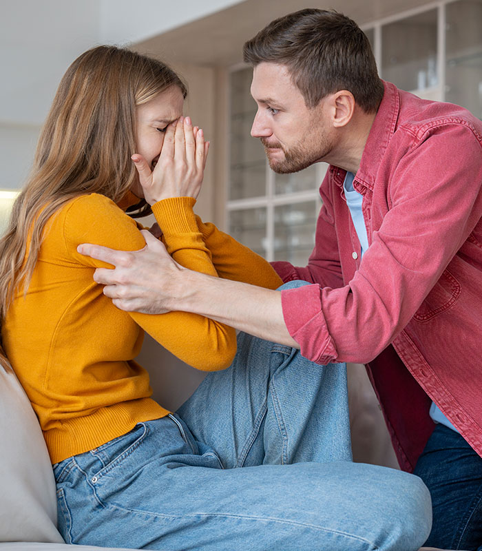 A frustrated ex-husband talking to his crying wife in a discussion on marriage sacrifices