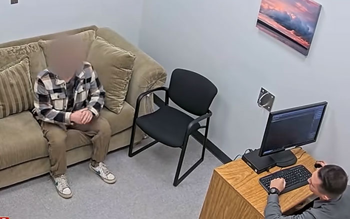 A young man sits on a couch in an interrogation room as a detective sits at a desk, linked to Cornell 7 student A young man sits on a couch in an interrogation room as a detective sits at a desk, linked to Cornell 7 student