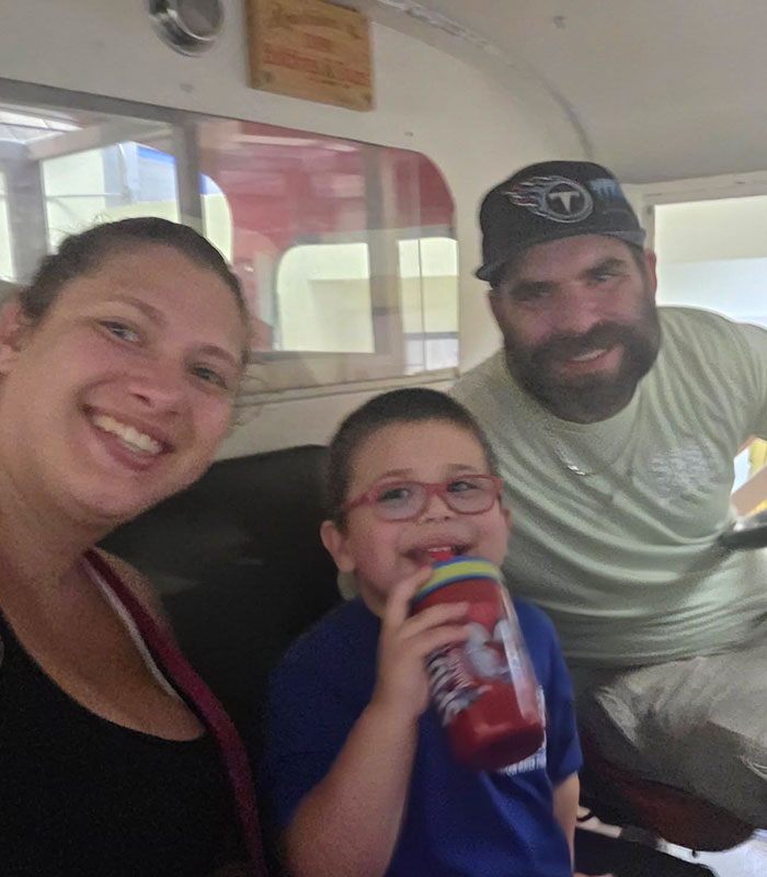 Happy family of three enjoying a ride at popular family resort
