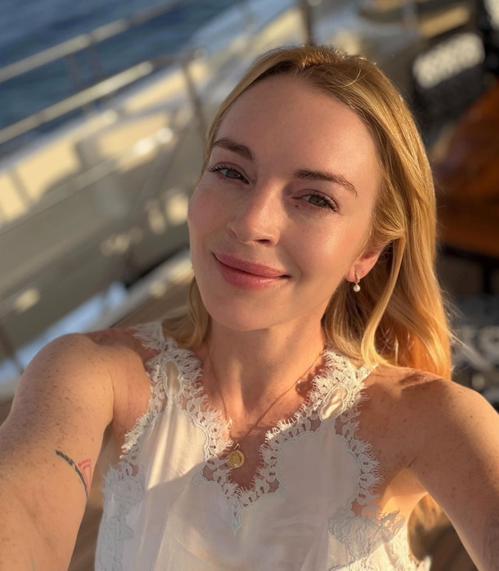 Smiling blonde woman with natural anti-Mar-a-Lago face outdoors Smiling blonde woman with natural anti-Mar-a-Lago face outdoors