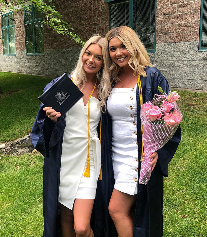 Two young women in white graduation dresses holding flowers and a diploma, linked to the Idaho tragedy
