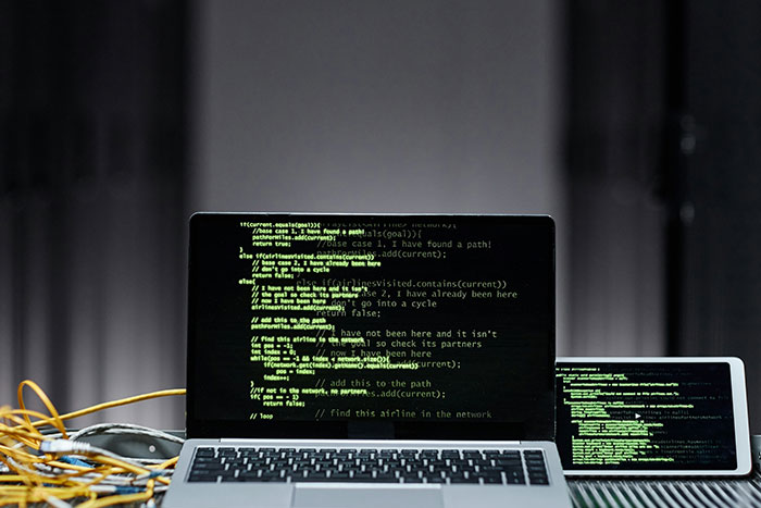 Laptop screen showing green code lines associated with AI agent swarms hacking networks. Laptop screen showing green code lines associated with AI agent swarms hacking networks.