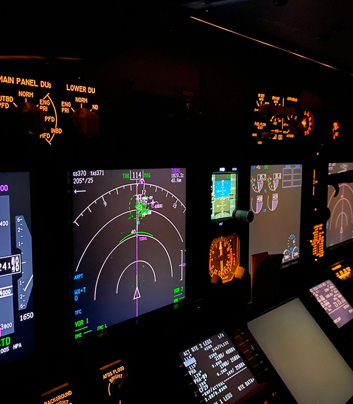 Illuminated instrument screens inside an airplane cockpit during nighttime flying. Illuminated instrument screens inside an airplane cockpit during nighttime flying.