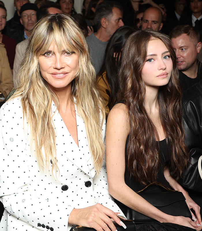 Heidi Klum and her daughter Leni sitting together at a public event amidst discussions on nepotism. Heidi Klum and her daughter Leni sitting together at a public event amidst discussions on nepotism.