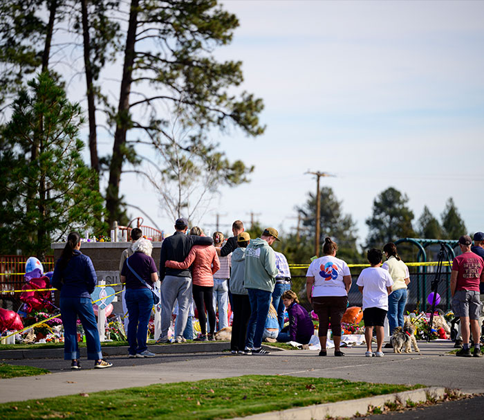 People gathering at a memorial for the Oregon elementary school tragedy