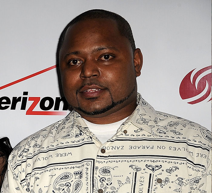 Kenneth Petty posing at an event related to Nicki Minaj and her problematic family history.