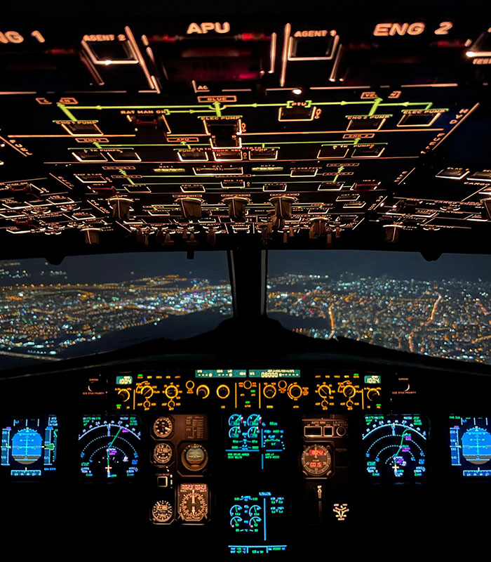 View from pilot's cockpit video looking over glowing city lights during nighttime flying. View from pilot's cockpit video looking over glowing city lights during nighttime flying.