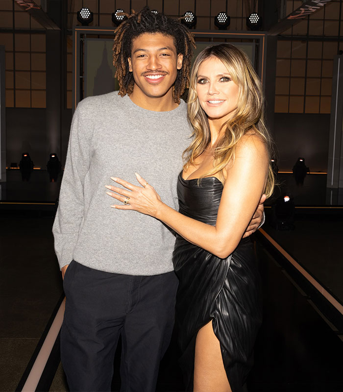 Heidi Klum posing next to a smiling young man amidst nepotism discussions Heidi Klum posing next to a smiling young man amidst nepotism discussions