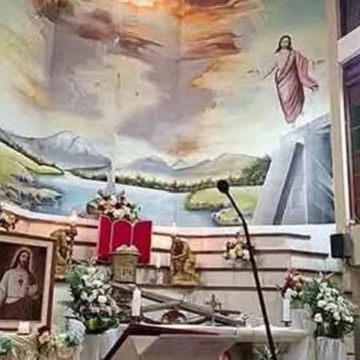 Empty altar with crucifix fallen and church mural in background Empty altar with crucifix fallen and church mural in background
