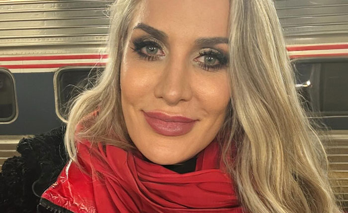 Close-up selfie of a blonde tall Domme wearing a red scarf in front of a train. Close-up selfie of a blonde tall Domme wearing a red scarf in front of a train.