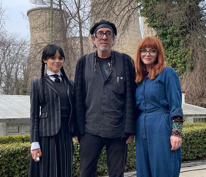 Jenna Ortega posing alongside Tim Burton and Christina Ricci on set. Jenna Ortega posing alongside Tim Burton and Christina Ricci on set.