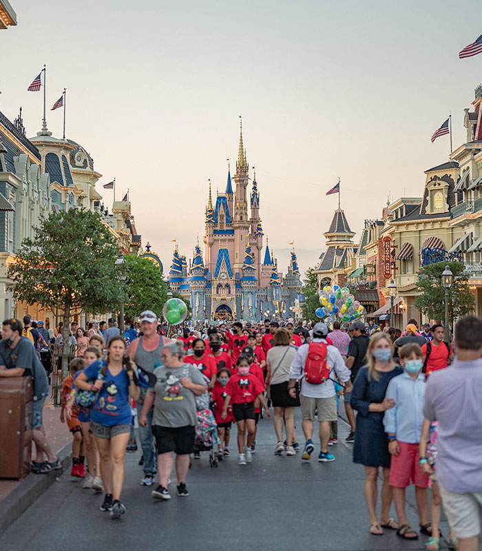 Crowd of Disney World guest visitors walking down Main Street U.S.A. toward Cinderella Castle. Crowd of Disney World guest visitors walking down Main Street U.S.A. toward Cinderella Castle.