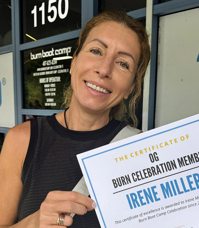 Mom who left kids home alone holding a fitness membership certificate indoors