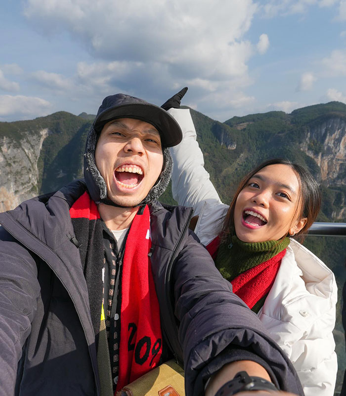 Happy couple outdoors taking a selfie, related to the story of a husband shamed online over a gaming contract. Happy couple outdoors taking a selfie, related to the story of a husband shamed online over a gaming contract.