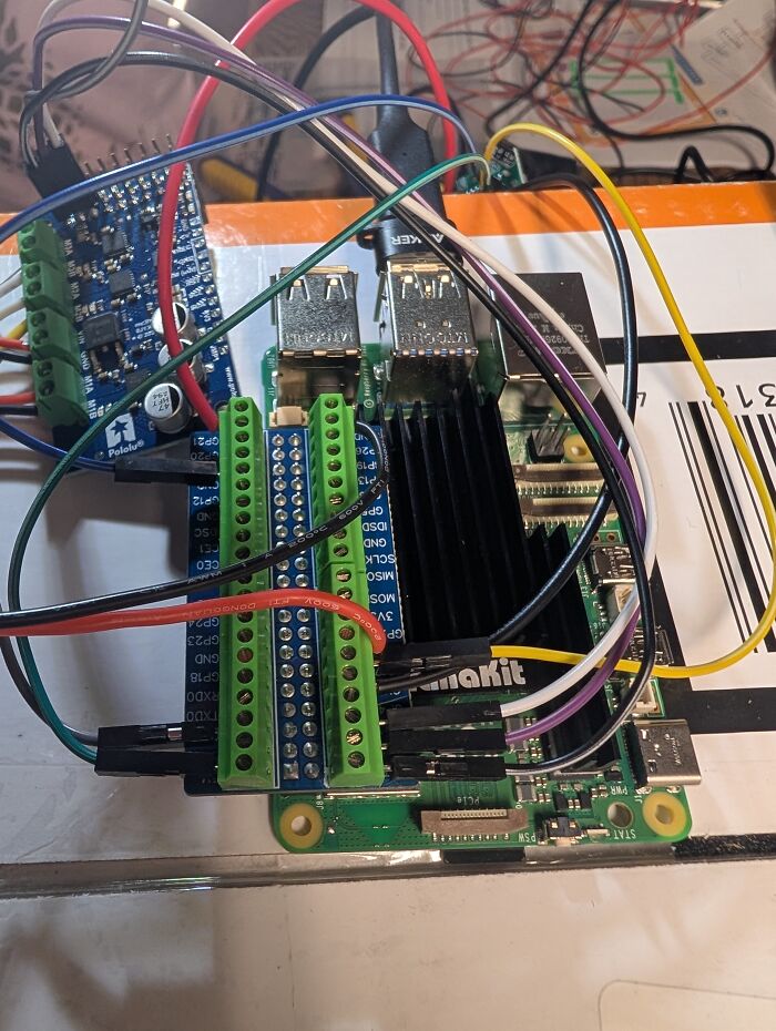 Close-up of a tiny computer circuit board connected with colorful wires. Close-up of a tiny computer circuit board connected with colorful wires.