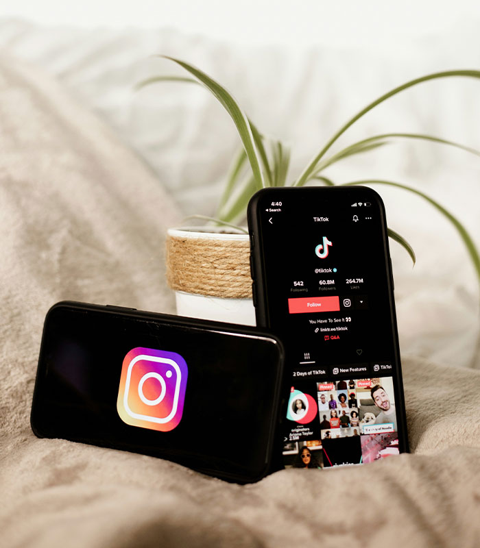 Smartphones displaying Instagram and TikTok apps representing influencer culture. Smartphones displaying Instagram and TikTok apps representing influencer culture.