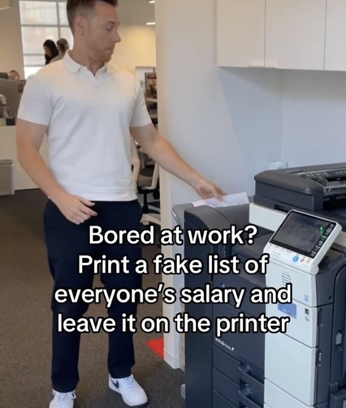 Man printing fake salary list at office printer about financial dystopia life