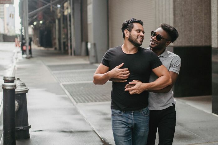 Happy couple sharing an affectionate moment on city street