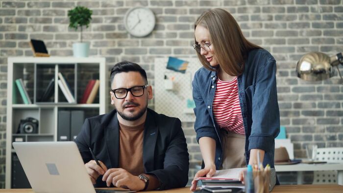 Colleagues discussing work at office sharing serious disturbing admissions