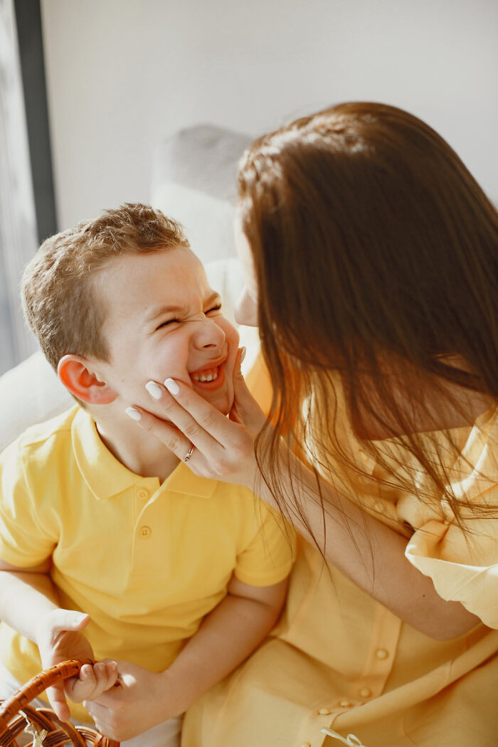 Mother holding playful child smiling before making the decision to choose divorce