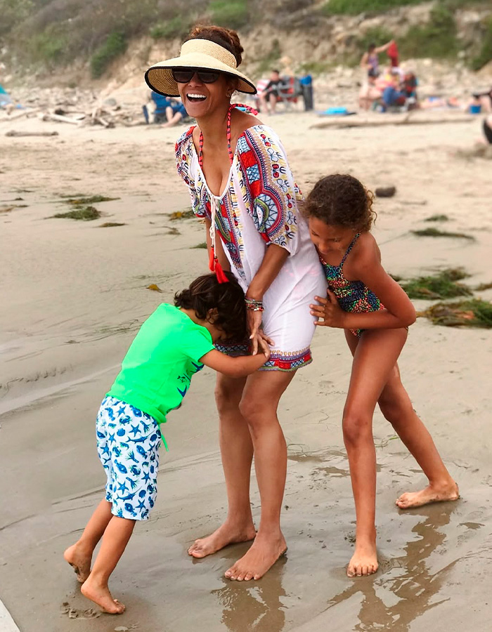 Halle Berry laughing on the beach with her son and daughter. Halle Berry laughing on the beach with her son and daughter.