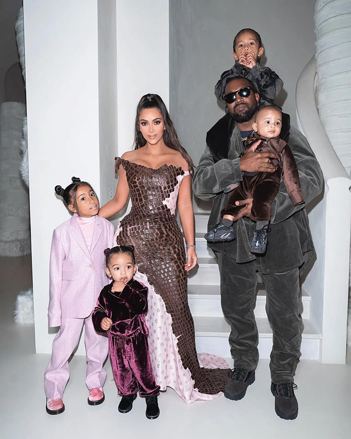 Kim Kardashian and Kanye West posing on stairs with their 4 kids in formal wear Kim Kardashian and Kanye West posing on stairs with their 4 kids in formal wear