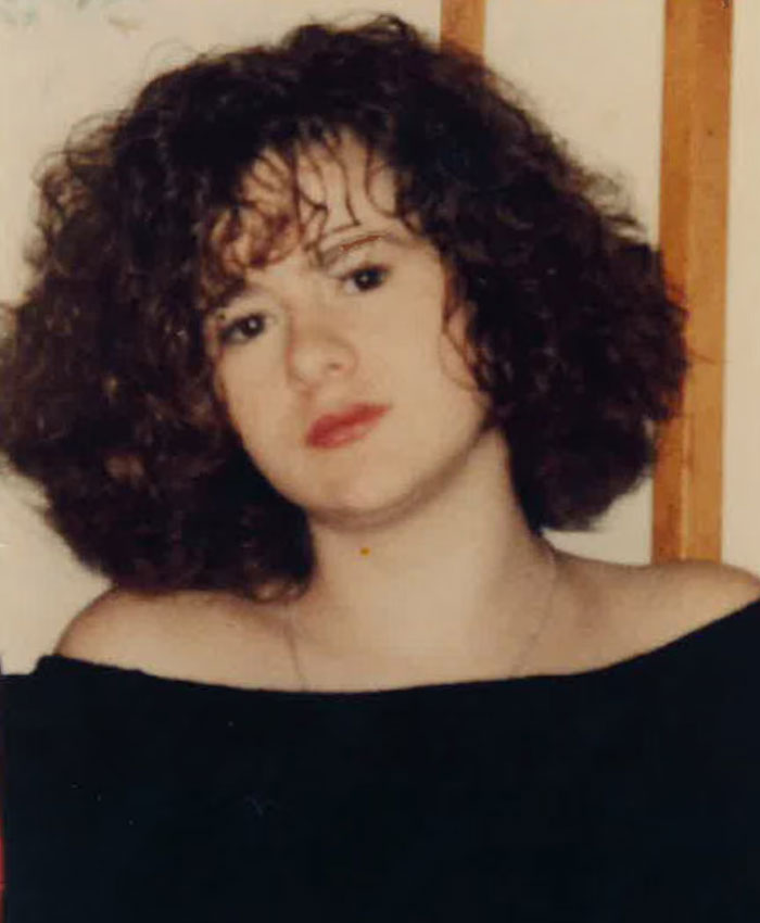 Portrait of a young Christa Pike with curly dark hair.