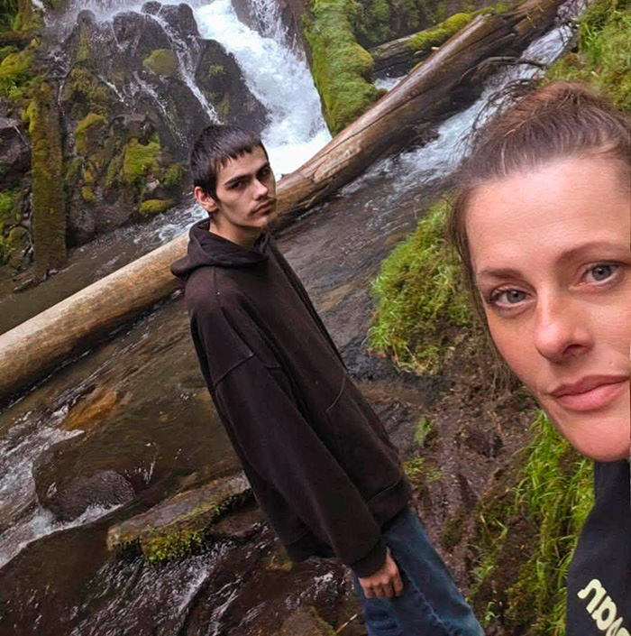 Mother and teen near a waterfall in nature setting