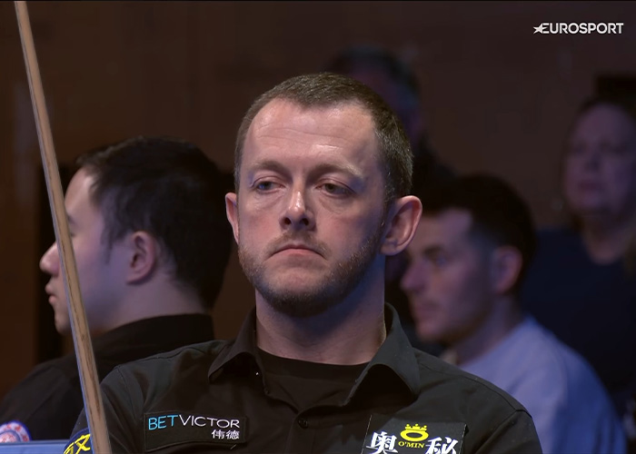 Snooker player looking serious mid-interview after open discussion.