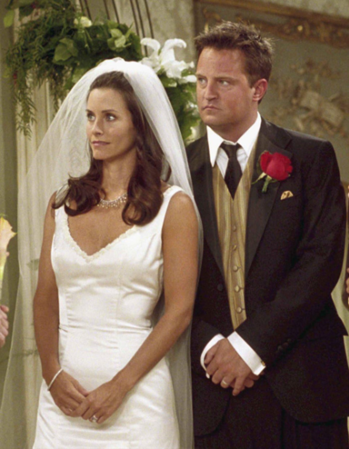 Matthew Perry as Chandler Bing stands at wedding altar with Courteney C*x in iconic Friends moment.