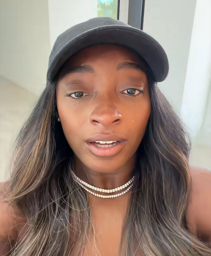Simone Biles teary-eyed in a black cap, emotional after selling her 1.2M Texas home with husband Jonathan Owens.