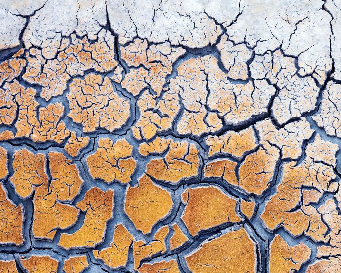 Detailed close-up of cracked, dry earth showing intricate patterns in natural landscape photography.
