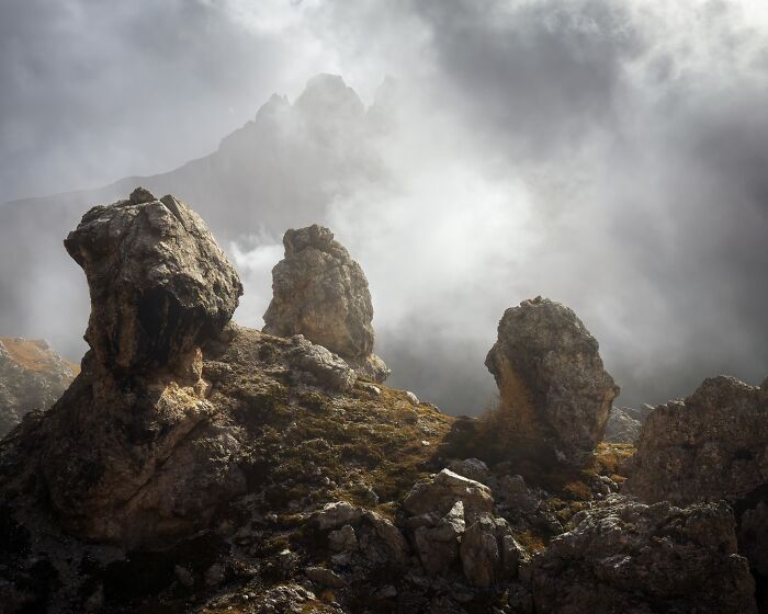Misty mountain peaks and large rock formations captured in natural landscape photography.