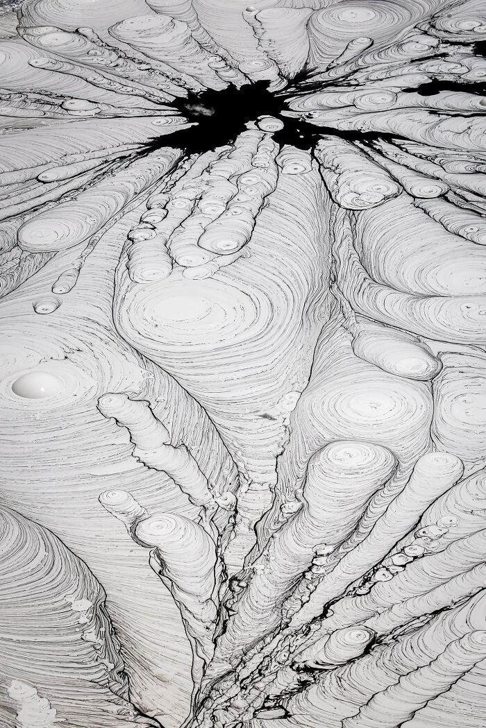 Abstract natural landscape photography of swirling mud pool patterns