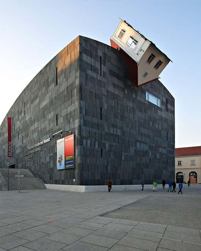 Modern art museum with strange building featuring an upside-down house on top