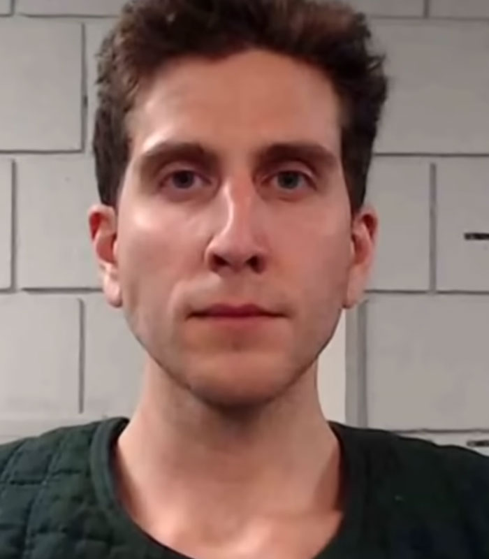 Close-up mugshot portrait of Bryan Kohberger looking directly at the camera