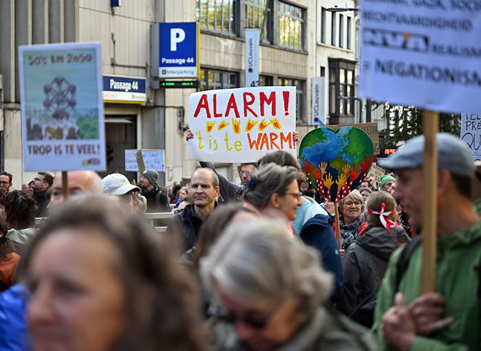 Protesters hold signs during a rally in France during a crackdown on civil unrest.