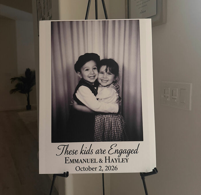 A black and white childhood photo sign of the couple whose Laguna Beach proposal was hijacked