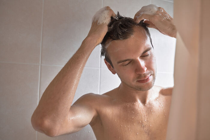 Man washing hair in shower showing refreshing moments in funny revenge stories