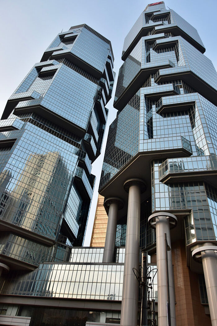 Modern strange twin skyscrapers with reflective glass and unique geometric shapes