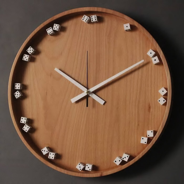 A round wooden wall clock using small dice as hour markers.
