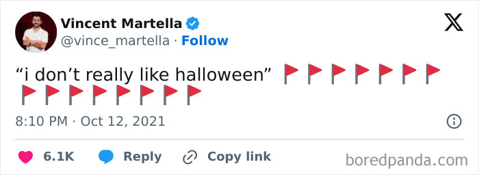 A hilarious Halloween tweet featuring a line about not liking Halloween surrounded by red flag emojis.