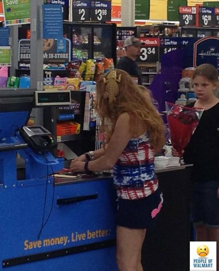 Woman shopping at Walmart checkout wearing patriotic tank top and shorts