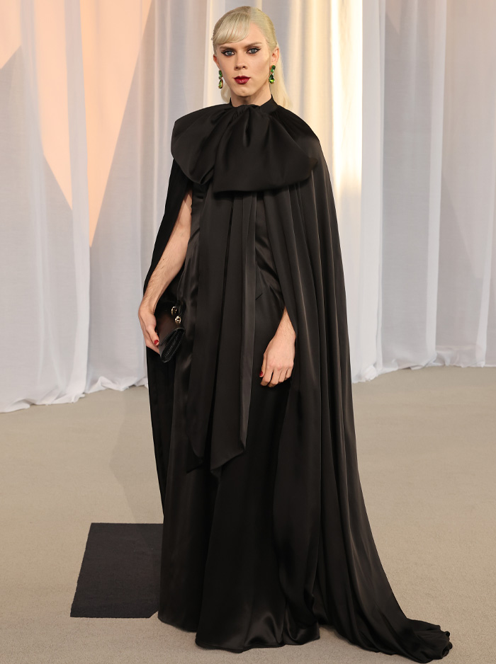 Person wearing black silk cape dress at Academy Museum Gala