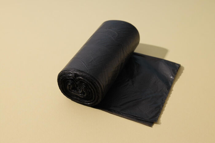 Roll of black plastic garbage bags, representing a partner's questionable intelligence about household chores