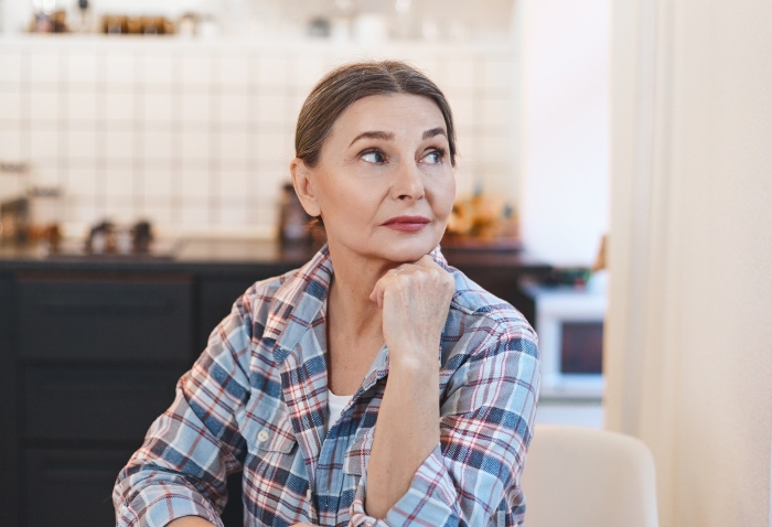 A thoughtful older woman representing the MIL shames DIL story context.