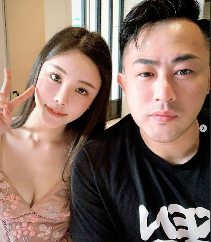 Couple posing for selfie, woman flashing peace sign Couple posing for selfie, woman flashing peace sign