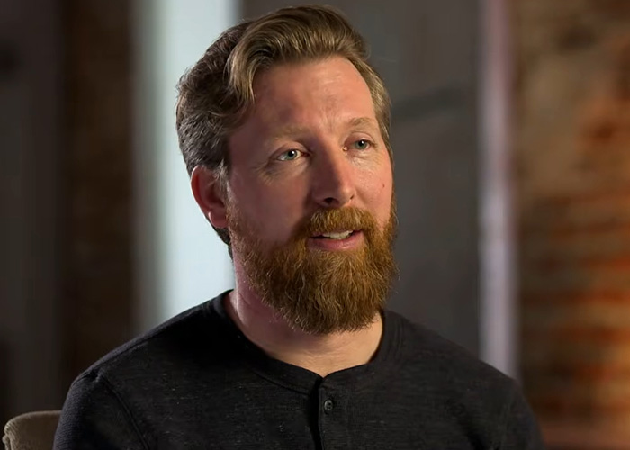 A bearded man featured in true crime stories discussing an investigation