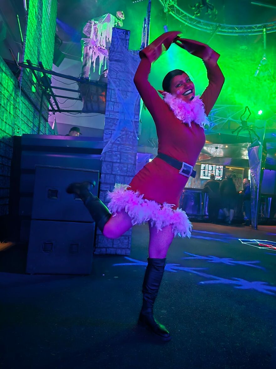 A person dressed as Him from Powerpuff Girls posing at a party, showcasing unique creative Halloween costume ideas.